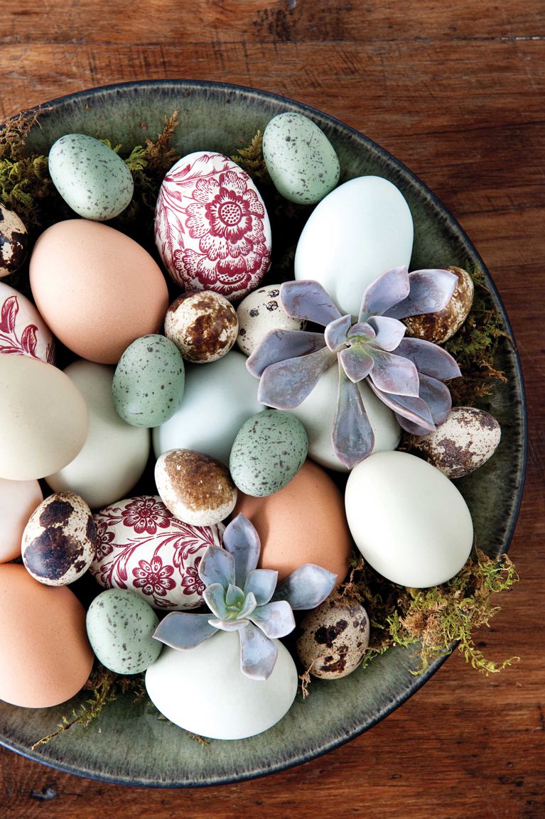 A wide, shallow pottery bowl is a modern take on the traditional Easter basket. Pretty paper napkins applied with decoupage glue are a quick and easy way to decorate undyed eggs. Add them to a moss-lined bowl along with natural and painted eggs and some succulents for an unique colourful arrangement.