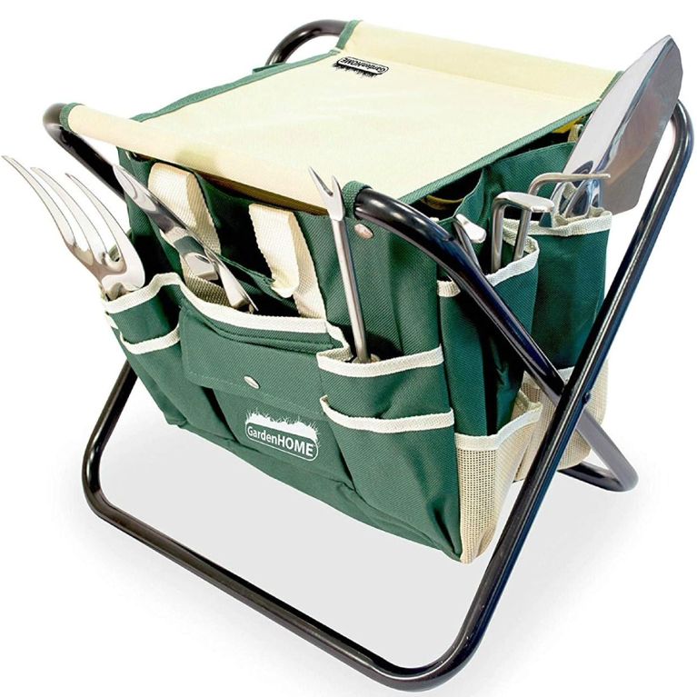 Dark green worker garden tool kit with multiple pockets surrounded by a weeding fork, cultivator, weeder, transplanter, trowel, folding stool and a tool bag.