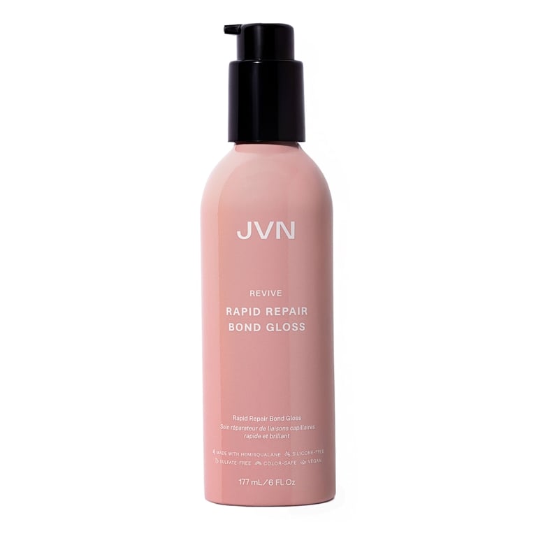 A pink bottle of JVN Rapid Repair Bond Gloss on white background for an article about the best hair gloss treatments.
