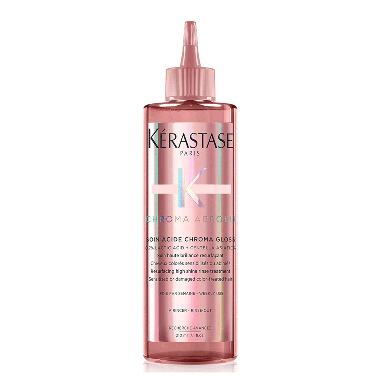 A pink bottle of Kérastase Chroma Absolu on white background for an article about the best hair gloss treatments.