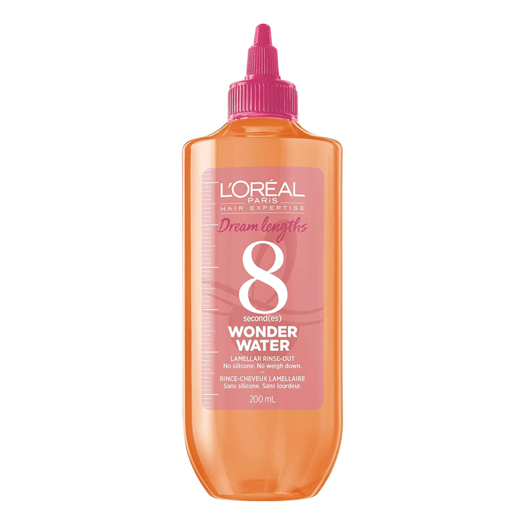 A pink and orange bottle of L'Oréal Paris Dream Lengths 8-Second Wonder Water Lamellar Rinse-Out on white background for an article about the best hair gloss treatments.