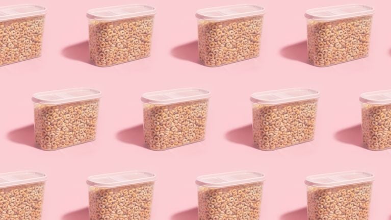 A repeating motif of cereal in clear plastic containers with pink lids on a pink background in a post about using ai for home organization.