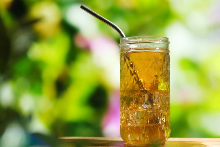 A glass tea pitcher with a stainless steel mesh insert for brewing hot and cold tea.