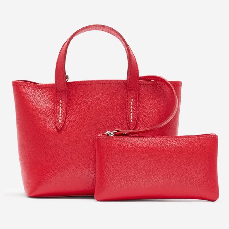 A red Roots leather bag for an article about the best purchases our editors made in June 2025.