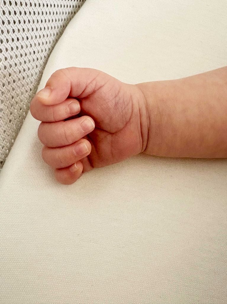 A photo of a baby's hand across a white backdrop, in a story about taking better photos on your iPhone.