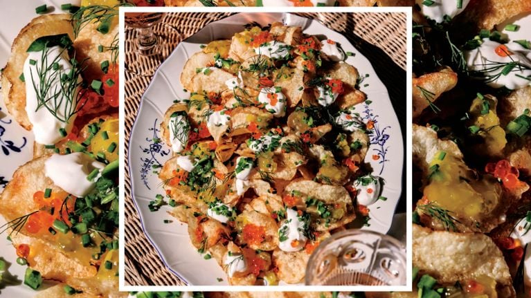 A platter of kettle chips topped with sour cream and roe, used in a recipe for no-bake kettle chip nachos