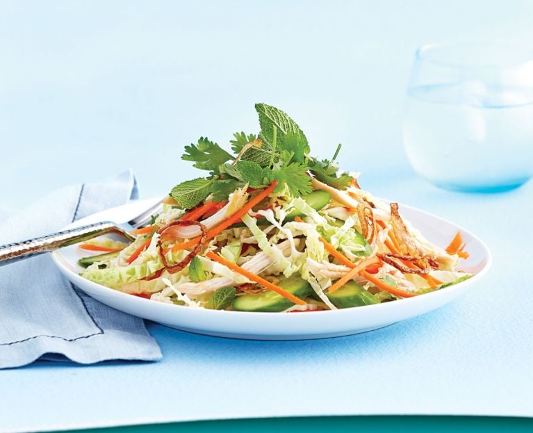A no cook-Thai-style rotisserie chicken salad made with Napa cabbage and carrot on a white plate for a post on an easy rotisserie chicken salad for a no cook meal recipe