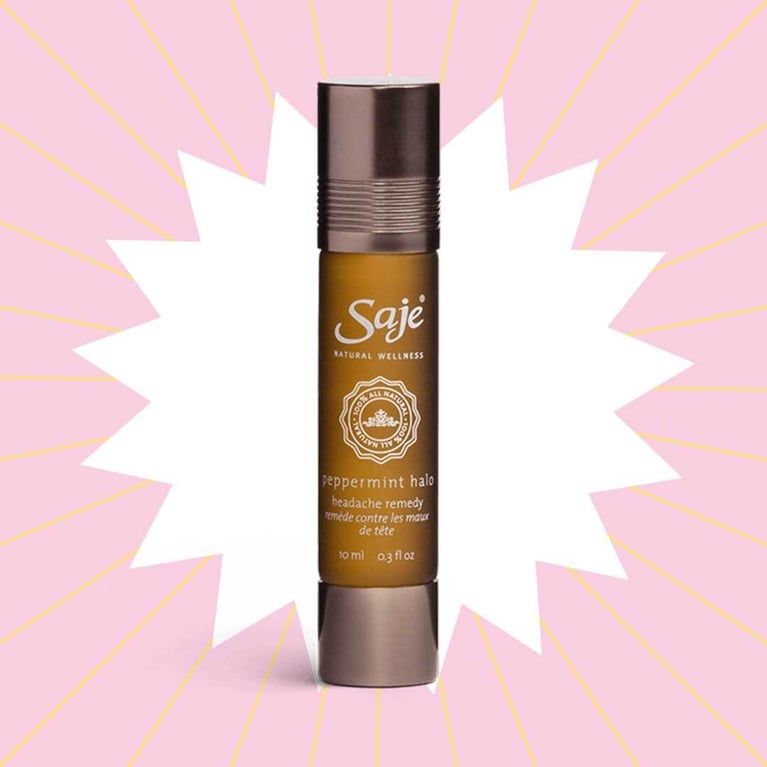 A brown glass rollerball of Saje Peppermint Halo on a pink background in a post about peppermint oil for headache relief.