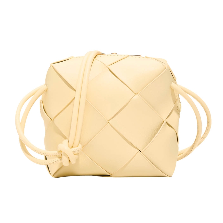 A butter yellow woven bag from Call It Spring for an article about how to wear the butter yellow fashion trend.