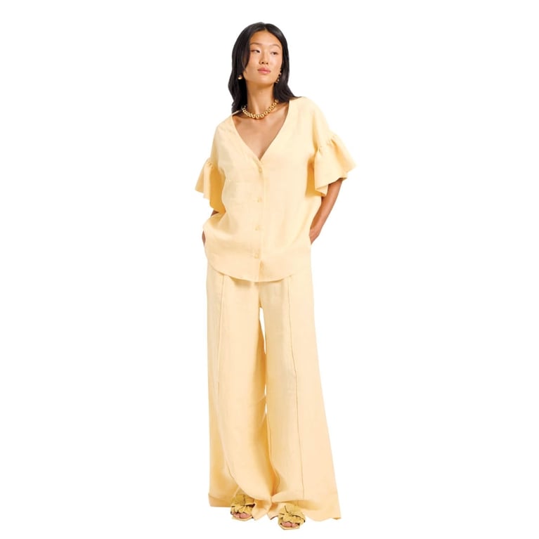 A butter yellow linen blouse and pants from Eliza Faulkner for an article about how to wear the butter yellow fashion trend.