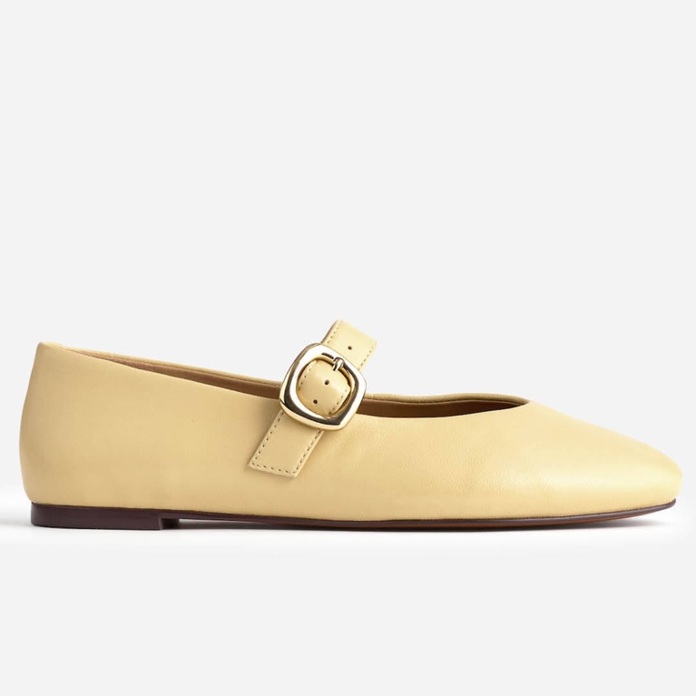 A pair of butter yellow ballet flats from Madewell for an article about how to wear the butter yellow fashion trend.