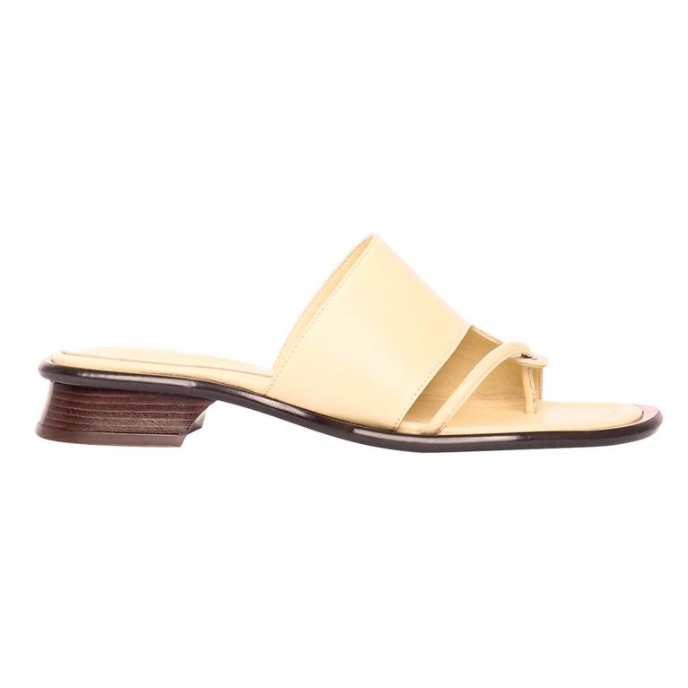 A pair of butter yellow sandals from Maguire for an article about how to wear the butter yellow fashion trend.