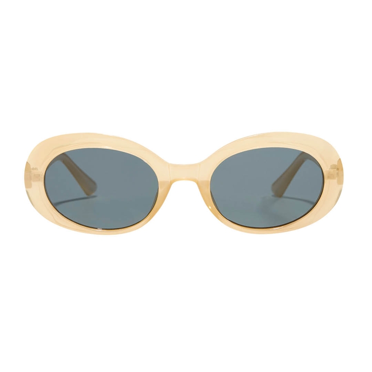 A pair of butter yellow sunglasses from Simons for an article about how to wear the butter yellow fashion trend.