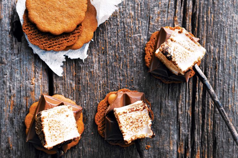 Someone holding a stack of s'mores ice cream sandwiches