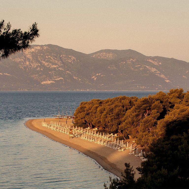A view of the beach and mountains for a review of the Club Med Gregolimano resort in Greece.