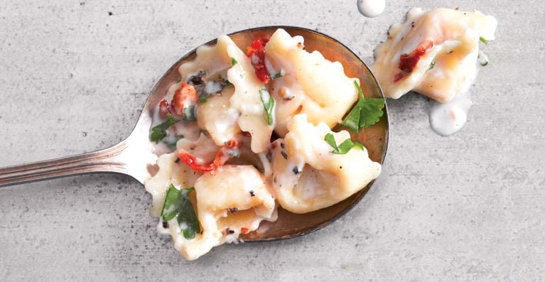 Creamy herbed-tortellini salad made with store-bought cheese tortellini; mayonnaise; sun-dried tomatoes; parsley; red-wine vinegar; Dijon mustard for a post on a n easy creamy herbed tortellini salad recipe