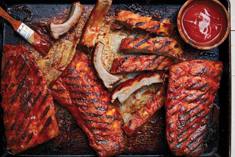 Drippy BBQ ribs with a DIY sauce on a sheet pan for a post on an easy bbq rib recipe with diy barbecue sauce