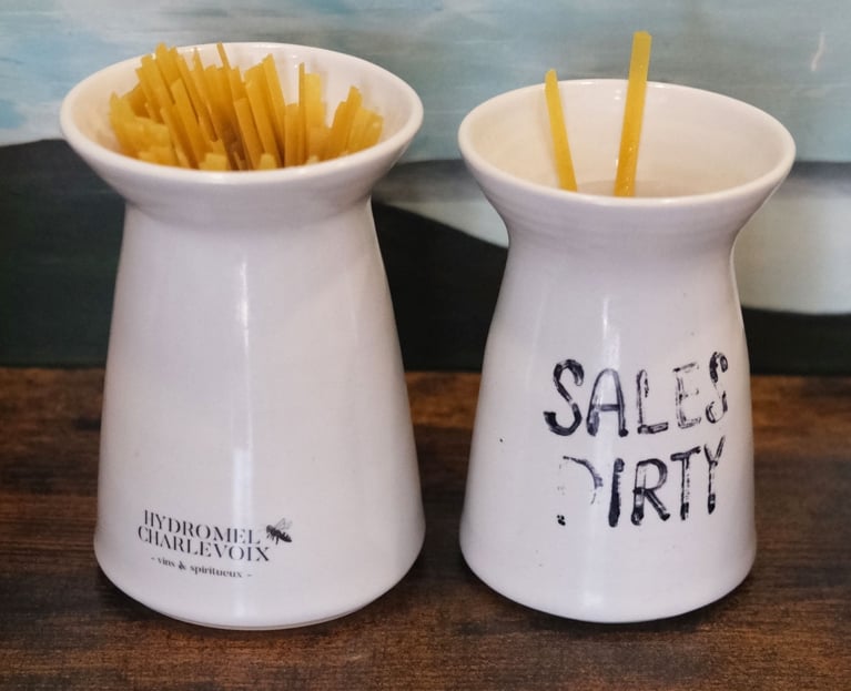 A jar of broken linguine strands with the label "sales/dirty" one on