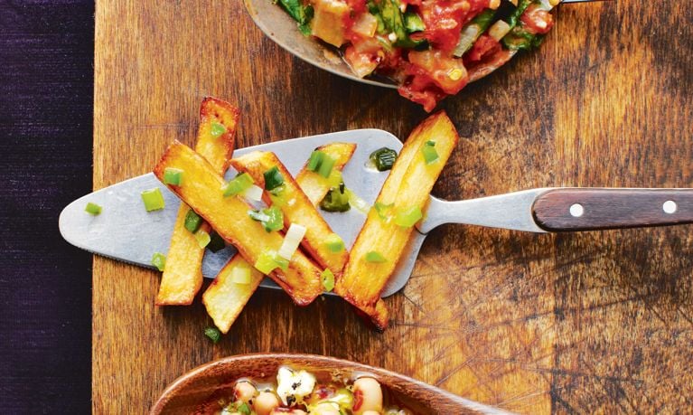 Jalapeno pan fries on a serving spoon, the fries are made in a pan with with yellow potatoes; green onions, oil and jalapeños for an easy pan fries recipe that's spicy