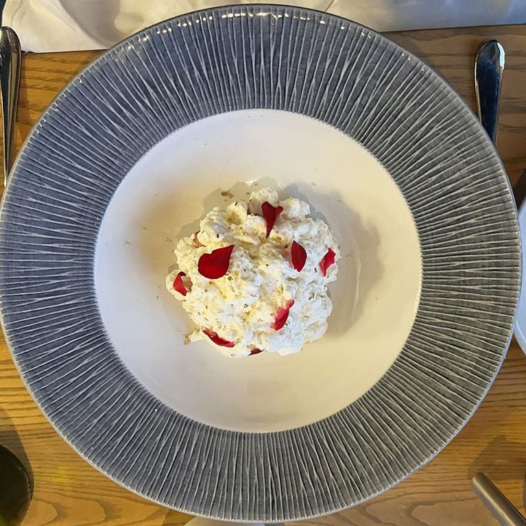 A strawberry and sweet cheese dessert on a plate at le saint Laurent at Fairmont Manoir le richelieu in Charlevoix