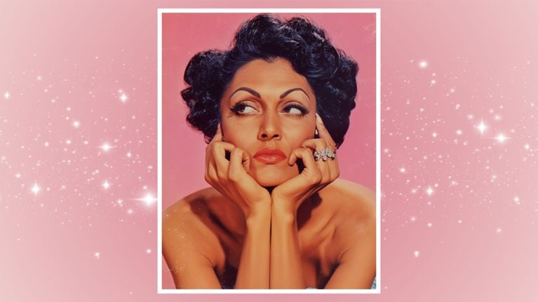 A pinup model with her hands resting on her chin on a pink starry background, for a story about sexual desire and libido.