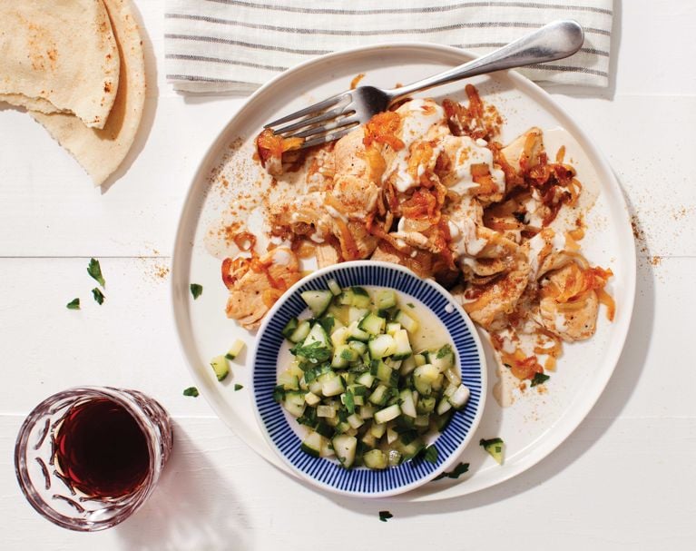 Spiced tahini chicken with cucumber salad on a plate for an easy weeknight dinner recipe