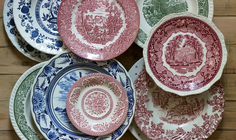 A woman shops for dishes at a garage sale.