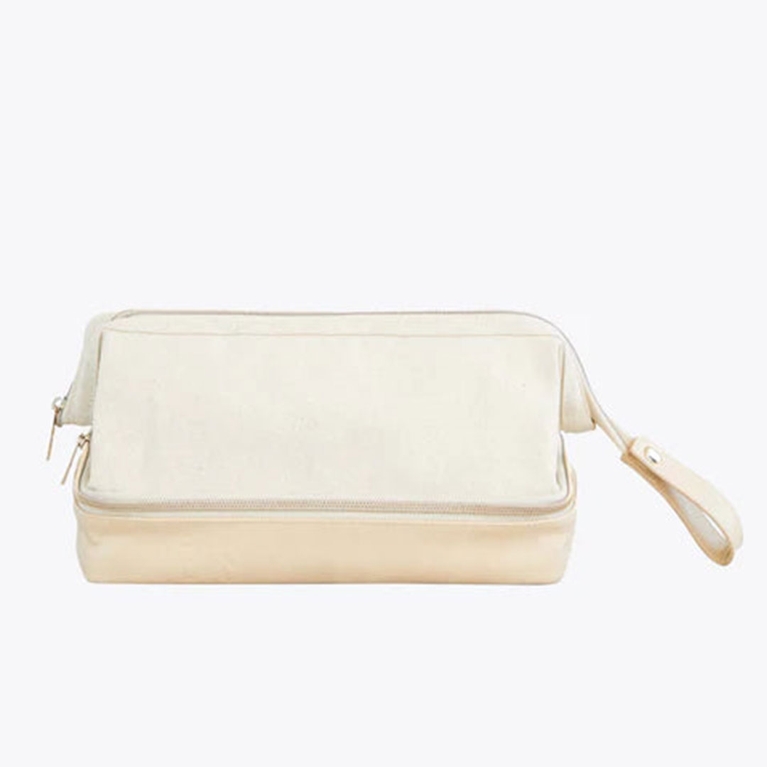 A beige Beis makeup case, one of the best makeup bags to shop for 2025.