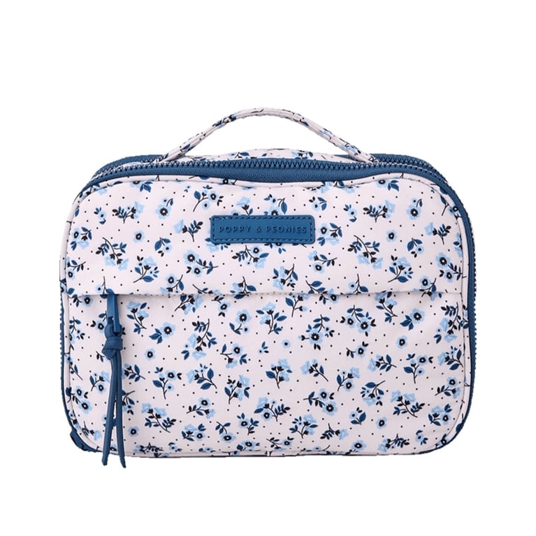 A blue floral Poppy & Peonies makeup case, one of the best makeup bags to shop for 2025.