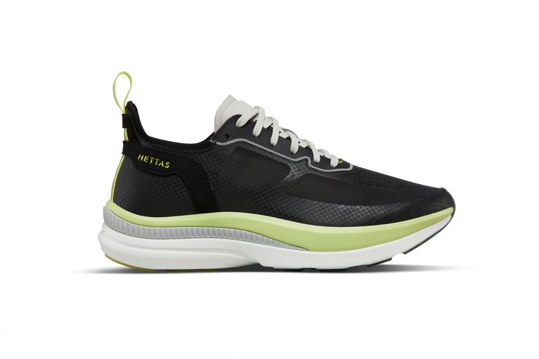 A photo of a black Hettas running shoe with green and white details for a post on running shoes for women.