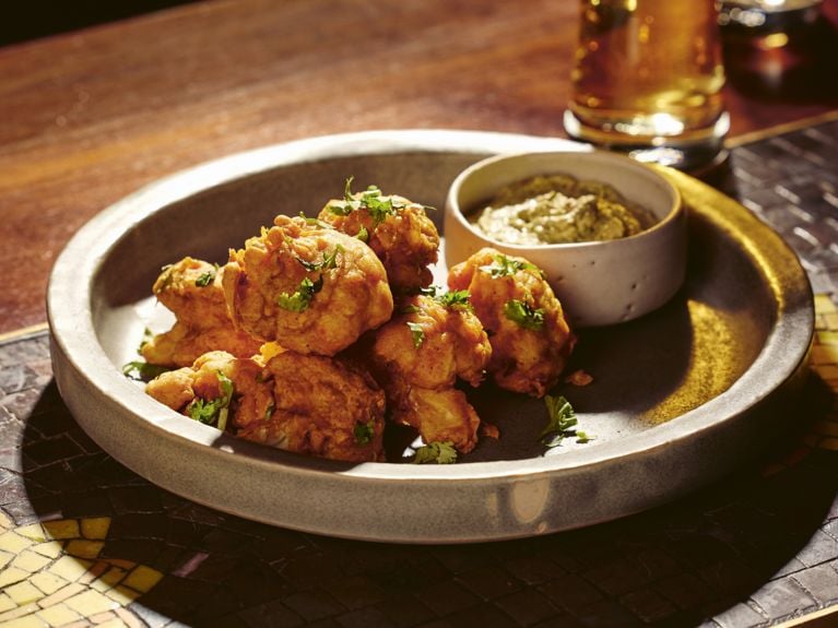 A plate of deep fried cauliflower fritters.
