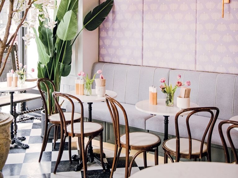Bistro tables on a checkerboard floor in the Laurier location of Mandy's Salads