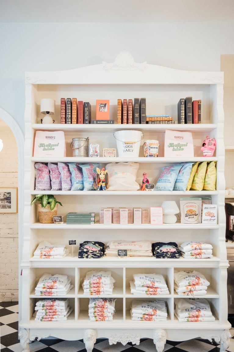 A white shelf filled with Mandy's merch in a post about Mandy's salads.