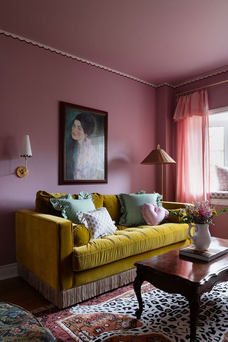 A maximalist living room makeover by Alexandra Gater with a yellow velvet fringe couch.