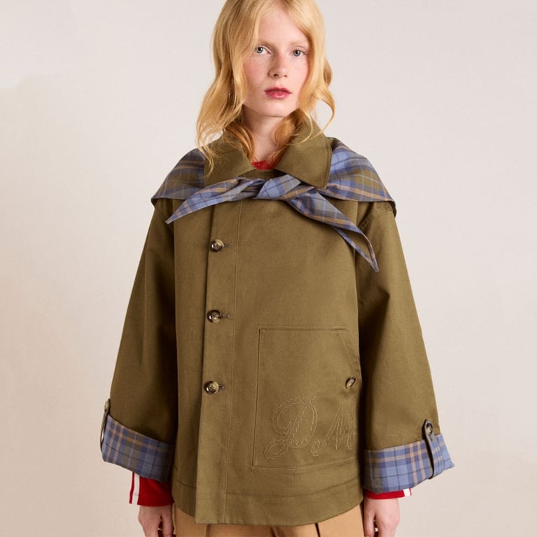 A model wearing a Damson Madder cropped trench coat for an article about updated basics for fall 2025.
