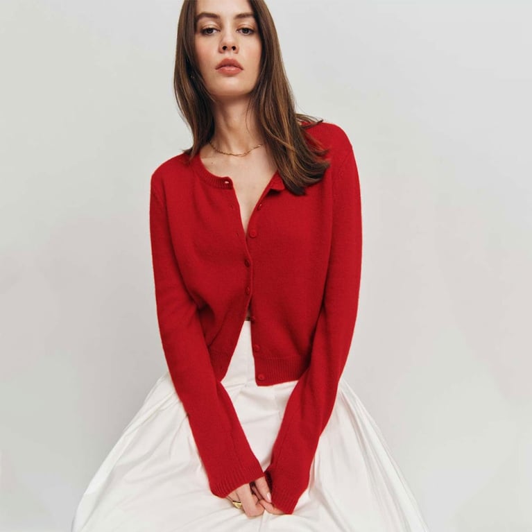 A model wearing a red Reformation cardigan for an article about updated basics for fall 2025.