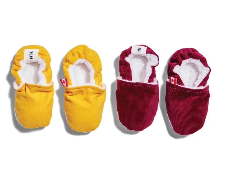 A pair of red and a pair of yellow baby shoes from brand Newbornlander.