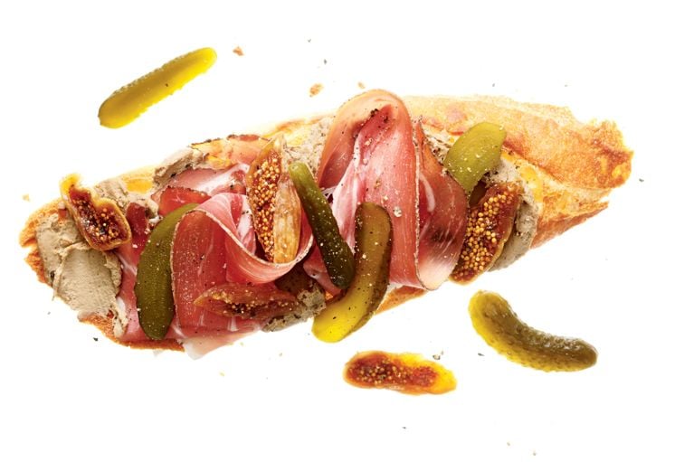 a charcuterie sandwich made with cornichons, Pâté, smoked prosciutto and brandy-soaked figs