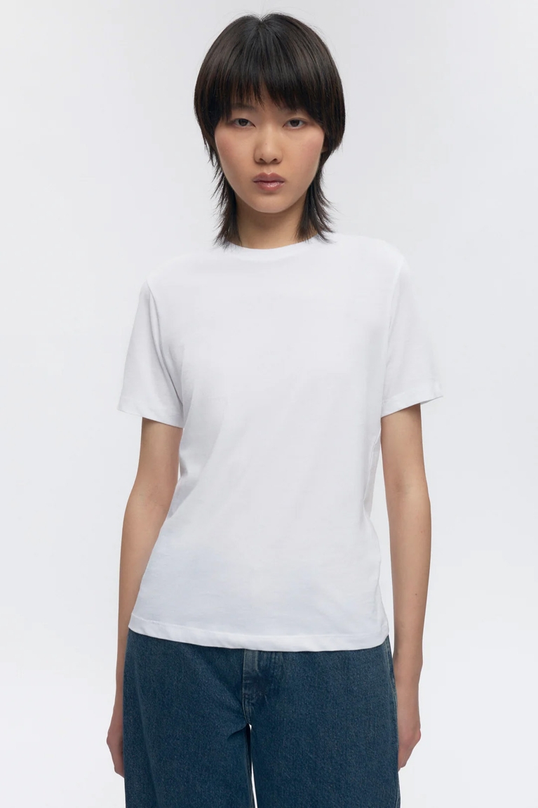 A white t-shirt from Canadian B Corp Kotn worn by a model for a piece on the eco and sustainability labels with real meaning