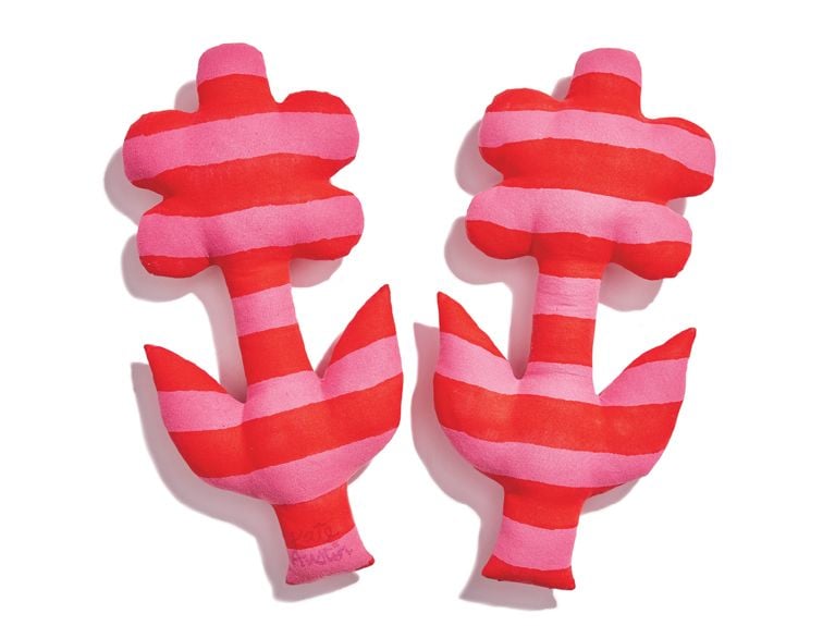A pair of red-and-pink-striped flower pillows from designer Kate Austin.