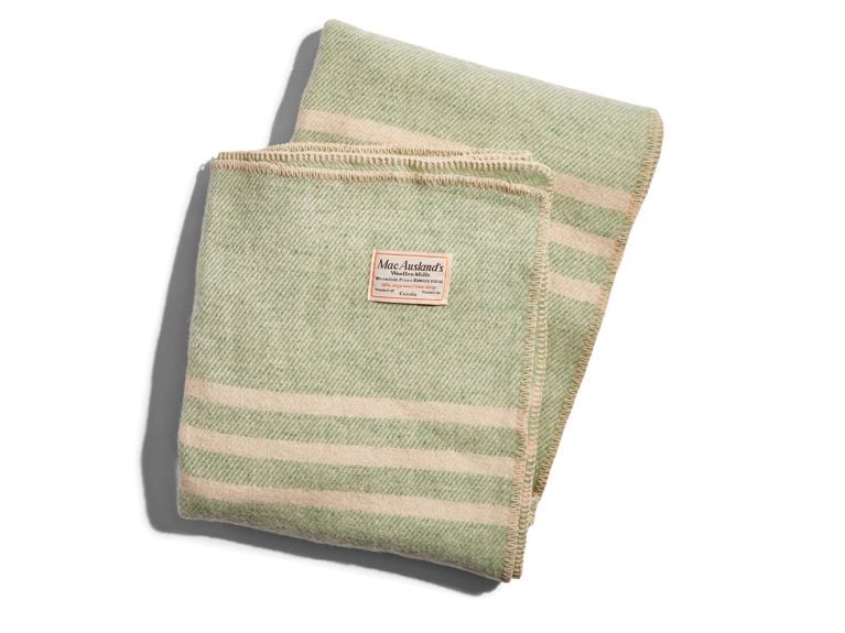A green and cream-coloured wool blanket from brand MacAuslands Woollen Mills.