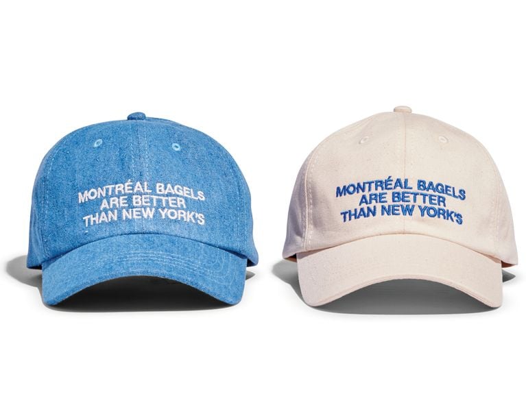 A pair of Province of Canada ball caps that read “Montreal bagels are better than New York's.”
