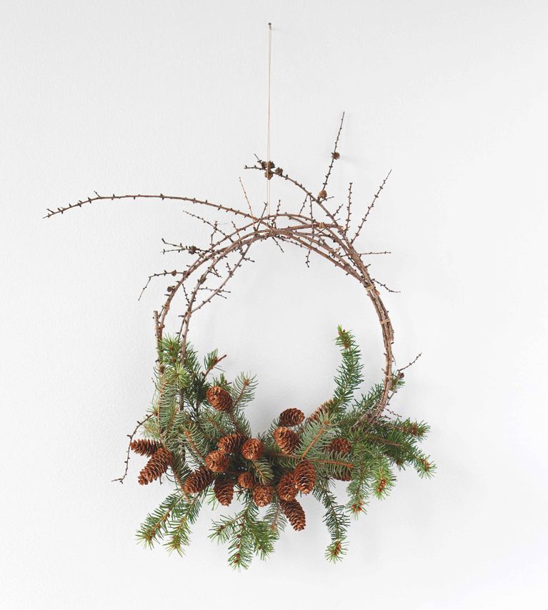 A wreath made of foraged pine tree boughs and pinecones