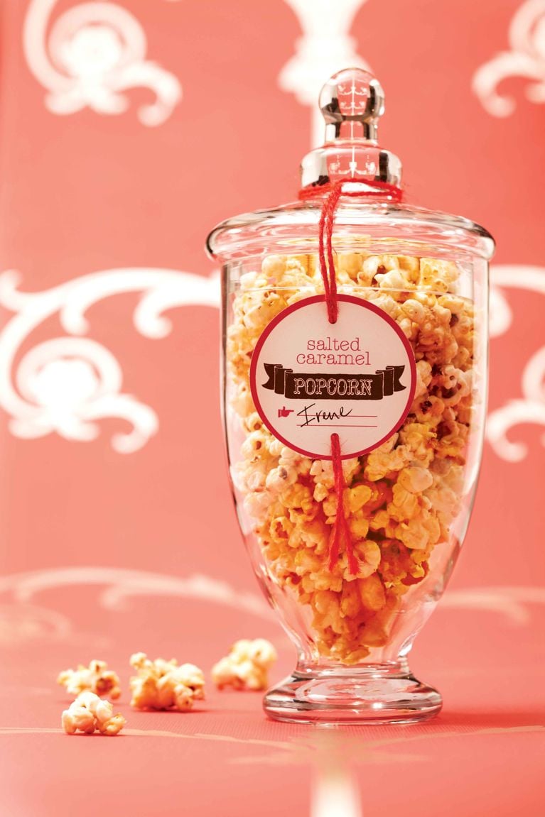 A glass jar filled with homemade salted caramel popcorn and a gift label reading salted caramel popcorn irene