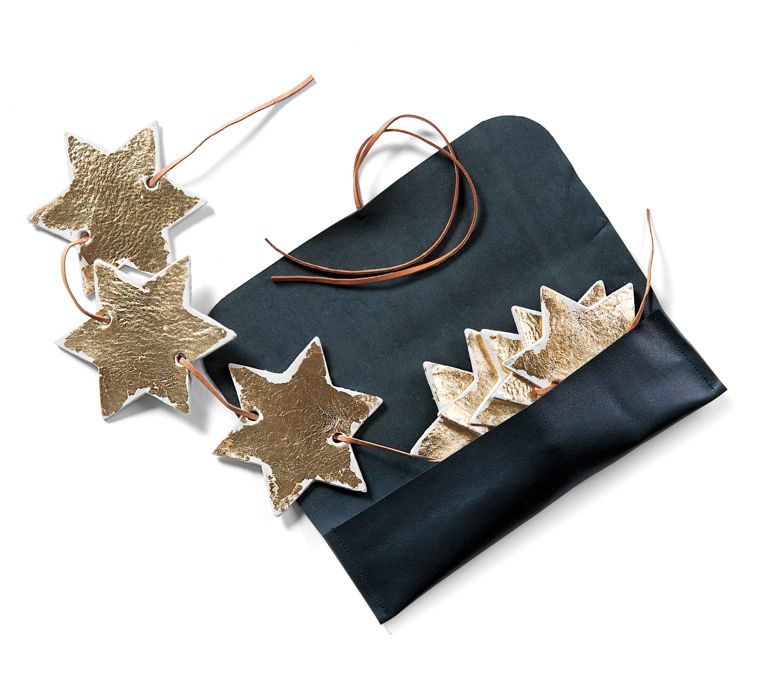 A starry Hanukkah banner with gold clay stars in a leather pouch for a post on homemade gifts