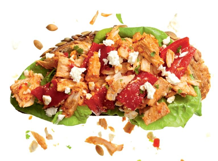 A tuna salad sandwich made with roasted red peppers, pecans, and feta for a post on a gourmet tuna salad sandwich recipe