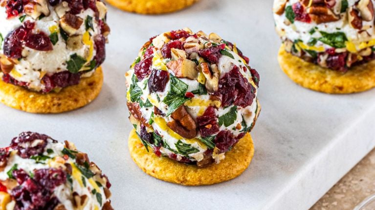 Small round cheese ball appetizers on crackers.