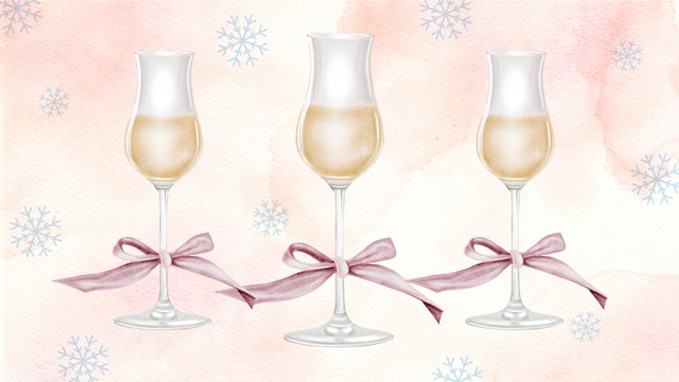 Three icewine glasses with pink bows tied around the stems sit in a row.