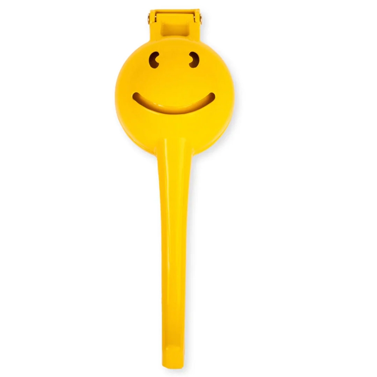 A bright yellow citrus squeezer with a happy face instead of drain holes