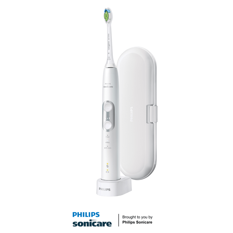 A white toothbrush on stand with case in background.